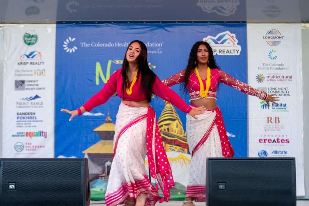 Two women dance on stage at Nepali Jatra